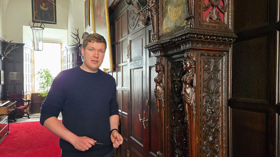 Kastelán zámku Opočno Tomáš Kořínek u hodin, kterým se kvůli zvuku přezdívá Big Ben | foto: Vladislava Wildová, Český rozhlas Kastelán zámku Opočno Tomáš Kořínek u hodin, kterým se kvůli zvuku přezdívá Big Ben