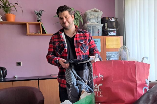 Vedoucí kontaktního centra Prevent v Prachaticích Jindřich Vindish probírá oblečení,  které lidé darovali ve sbírce | foto: Kristýna Barchini,  Český rozhlas